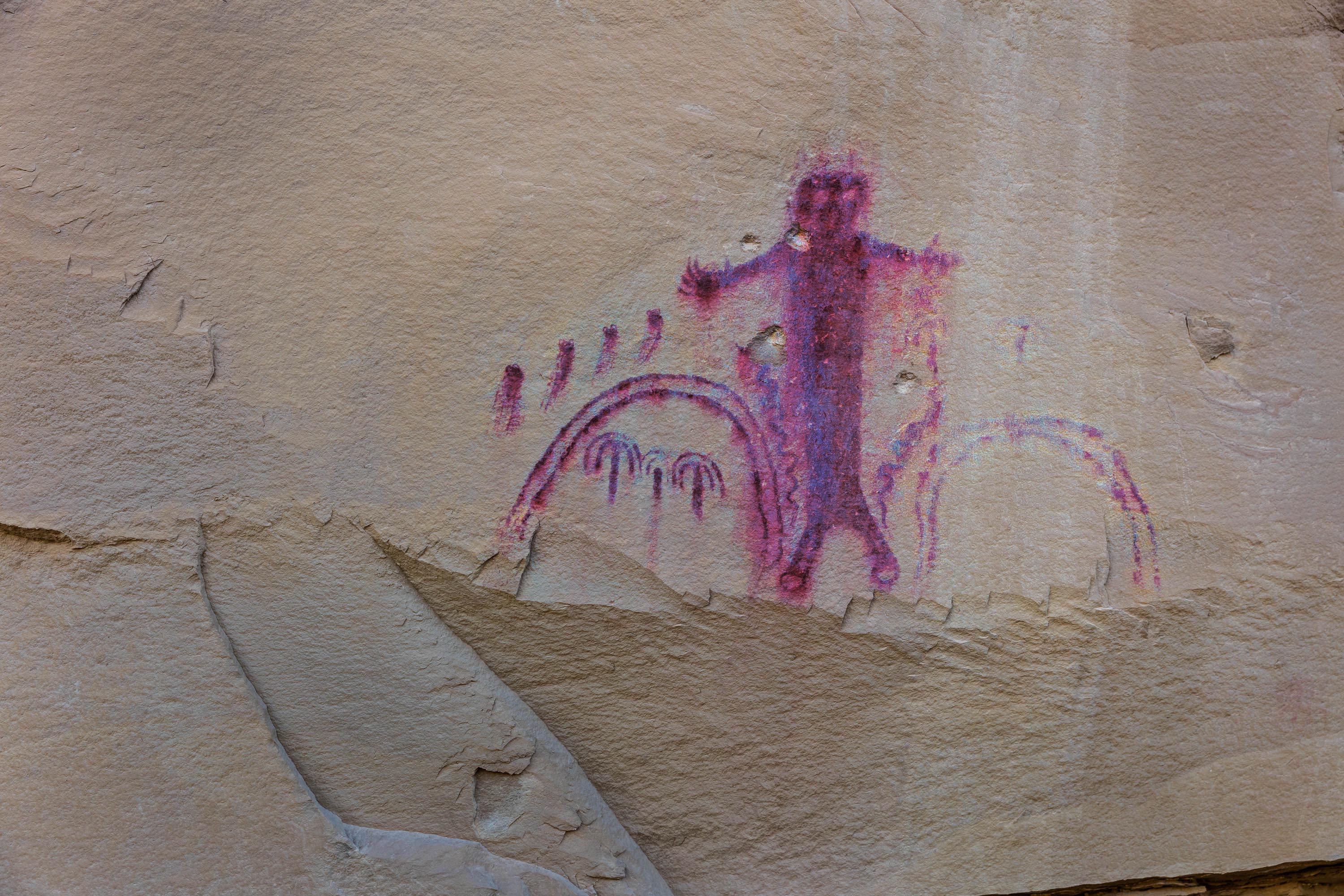 A horned anthropomorphic petroglyph with rainbows. Enhanced with D-Stretch