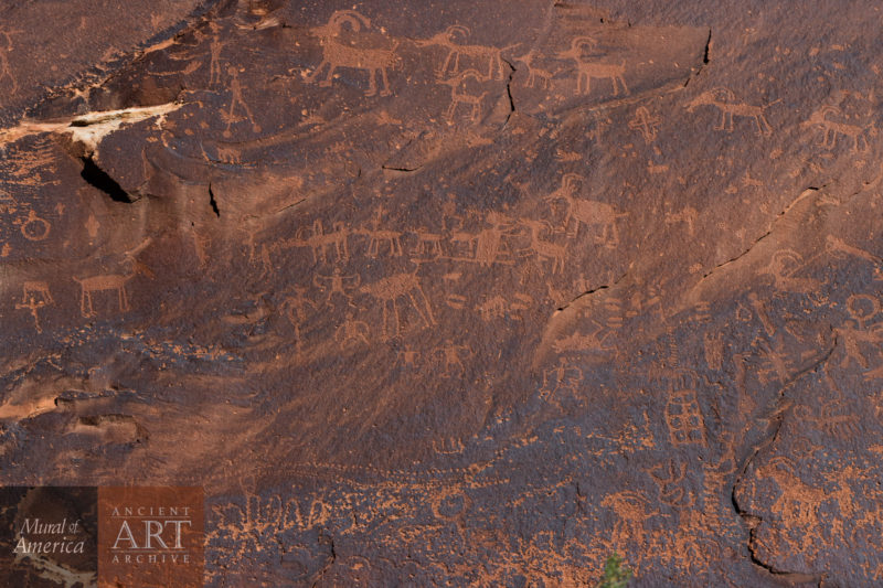 A stitched panorama of the extensive petroglyphs on the Sand Island rock art site of the San Juan River, Utah. The extensive panel has art that spans archic to modern times.