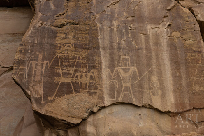 Fremont anthropomorphic figures hold a severed head on a Petroglyph panel at McConkie Ranch in Uintah County, Utah. McConkie Ranch is the type site for Classic Vernal Style Fremont artwork.