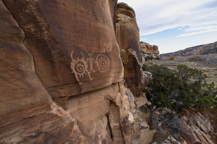 McConkie Ranch Petroglyphs in Uinta County Utah. A small anthropomorphic figure with circular shields on either side.